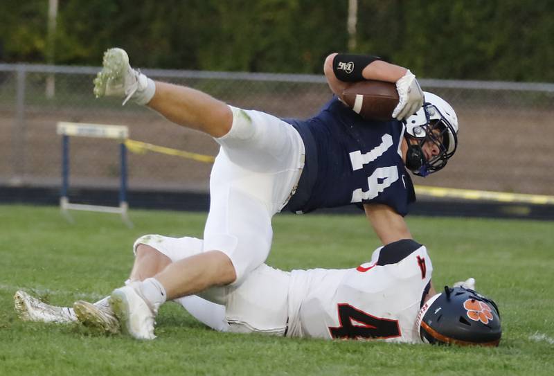 Cary-Grove's Ostin Hansen scores a touchdown as Crystal Lake Central's Carter Kelley tries to tackle hime after Hansen pick up a blocked punt during a Fox Valley Conference football game on Friday, Sept. 6, 2024, at Cary-Grove High School in Cary.