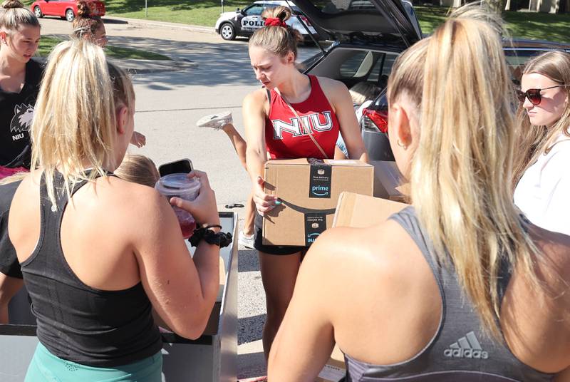 Members of the Northern Illinois University gymnastics team help move a teammate Thursday, Aug. 19, 2022, into New Residence Hall at NIU. Thursday was one of four move-in days for students attending the upcoming school year.