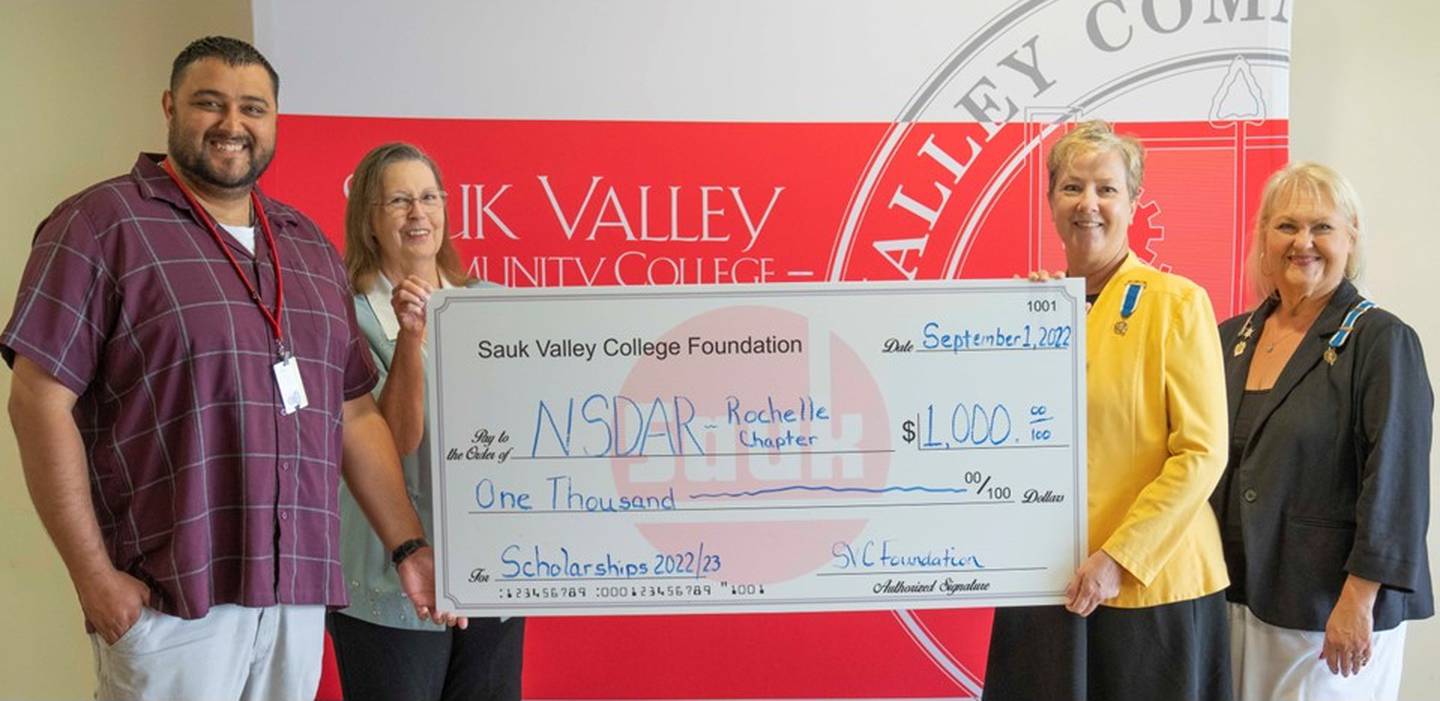 (Left to right); Daughters of the American Revolution Rochelle chapter members Rena Burgess, Laurie Perry, and Debby Katzman presenting a $1,000 check to Sauk Valley Community College Coordinator for Veterans Services Eric Valdez. The donation is the chapter's second annual to benefit veteran students at Sauk Valley Community College.