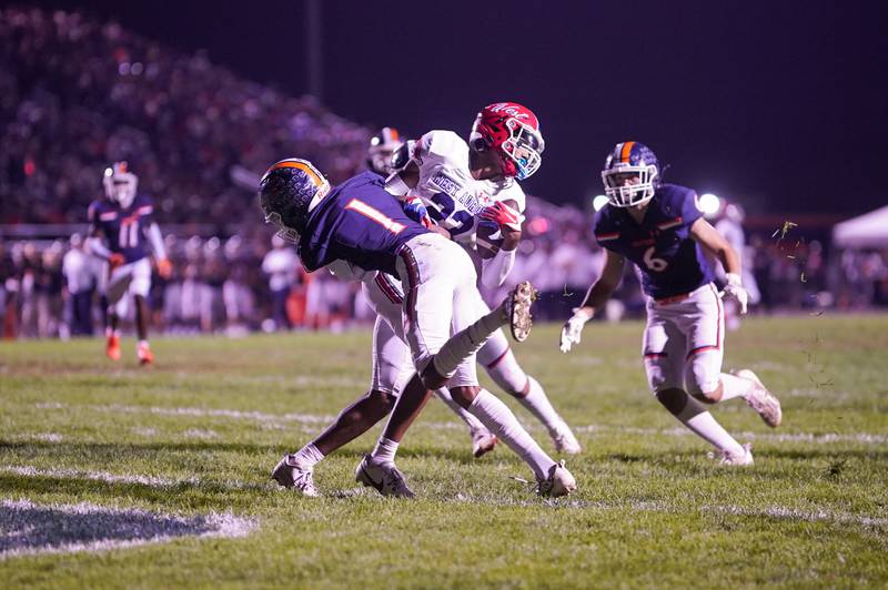 West Aurora's Terrence Smith (23) is hit after the catch by Oswego’s Jeremiah Cain (1) during a football game at Oswego High School on Friday, Sept. 29, 2023.