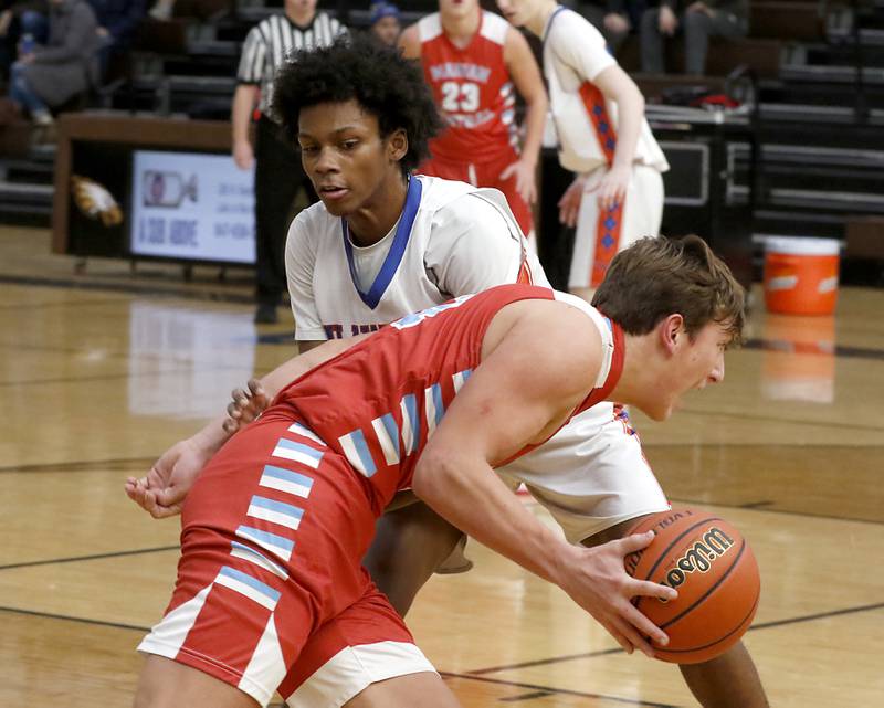 Marian Central's Christian Bentancur tries to drive against Hoffman Estates’ Trendell Whiting during a Hinkle Holiday Classic basketball game Tuesday, Dec. 27, 2022, at Jacobs High School in Algonquin.