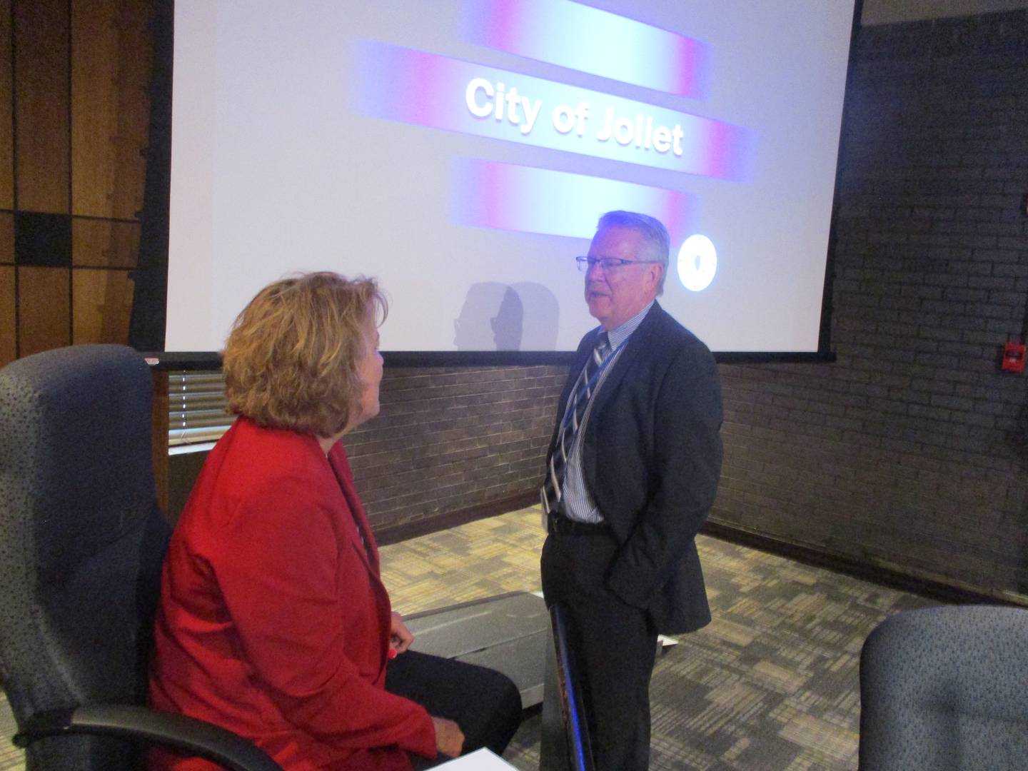 Newly hired interim City Attorney Todd Greenburg talks with Joliet Councilwoman Sherri Reardon before the Tuesday meeting where the council voted 5-4 to hire Greenburg. Aug. 1, 2023.