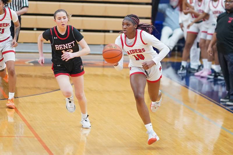 Bolingbrook's Trinity Jones (10) brings the ball up the court against Benet’s Lindsay Harzich (12) during a Oswego semifinal sectional 4A basketball game at Oswego High School on Tuesday, Feb 20, 2024.