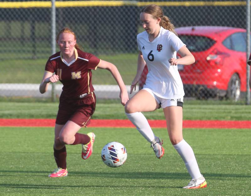 L-P's Katie Sowers kicks the ball away from Morris's Makensi Martin during the Class 2A Regional semifinal game on Wednesday, May 15, 2024 at the L-P Athletic Complex in La Salle.
