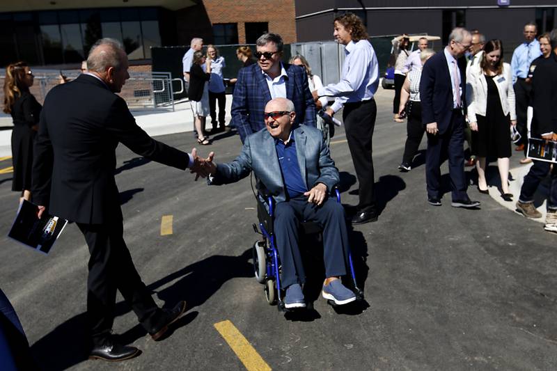 Vince Foglia and his son, Vinnie are greeted as they arrive for opening ceremony for the Foglia Center for Advanced Technology and Innovation on Tuesday, Sept. 3, 2024, at McHenry County College.