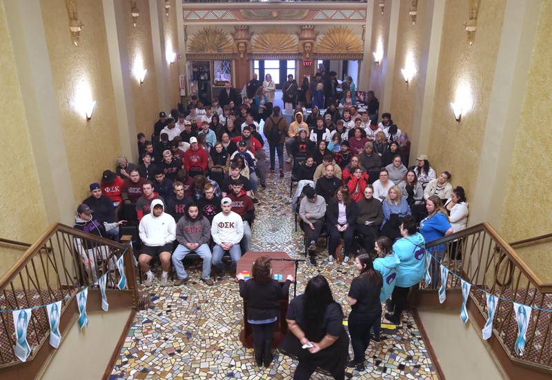 Attendees listen to speakers Tuesday, April 2, 2024, during Take Back the Night at the Egyptian Theatre in DeKalb. The event, hosted by Safe Passage, is in honor of Sexual Assault Awareness Month and featured speakers and a march.