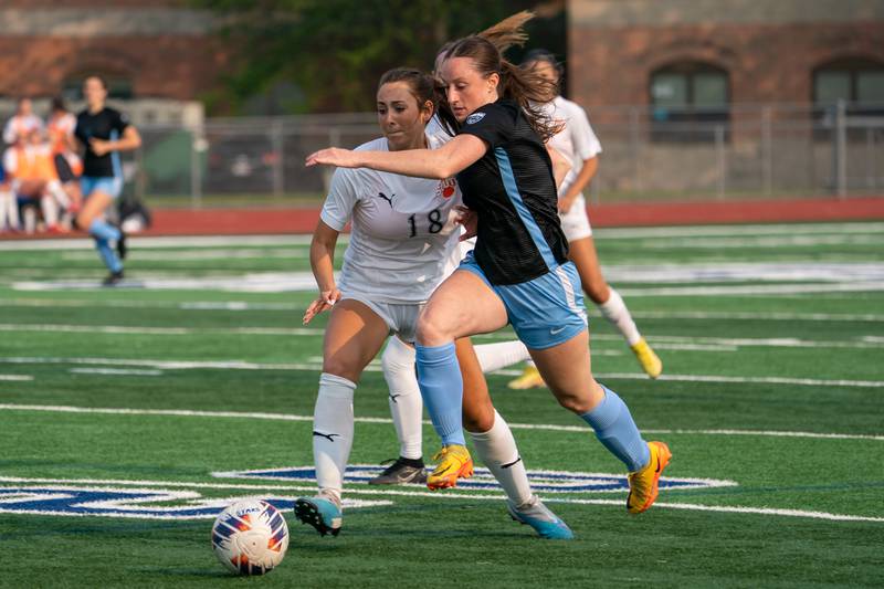 Wheaton Warrenville South's Ella McClatchy (18) challenges St. Charles North's Rian Spaulding (5) for the ball during the Class 3A girls soccer regional final at St. Charles North High School on Friday, May 19, 2023.