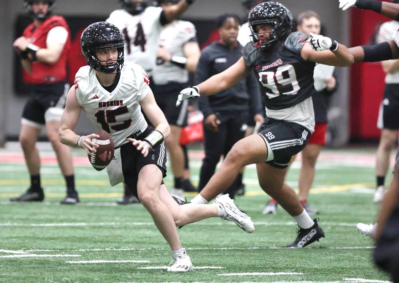 Northern Illinois University quarterback Josh Holst runs away from the pressure of defensive end Pierce Oppong Tuesday, March 26, 2024, during spring practice in the Chessick Practice Center at NIU.