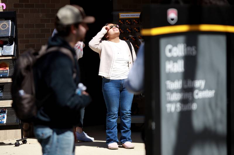 Waubonsee Community College student Melissa Hernandez of Aurora looks at the sun using special protective glasses during the solar eclipse on Monday, April 8, 2024 at the college’s Sugar Grove campus.
