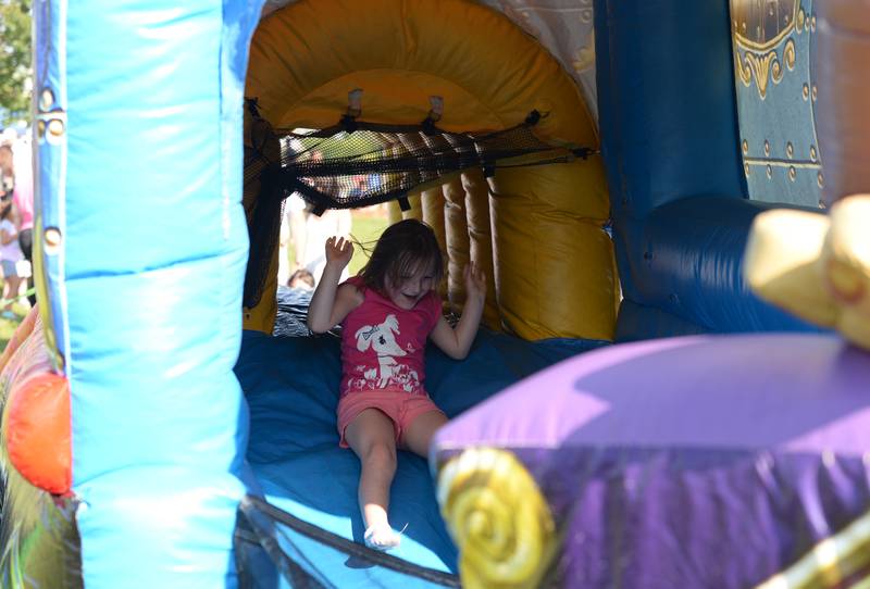 Children including Elliana Reschke of Schaumburg enjoy the inflatable train while attending the Park Palooza event held at Berens Park Saturday Aug 19, 2023.