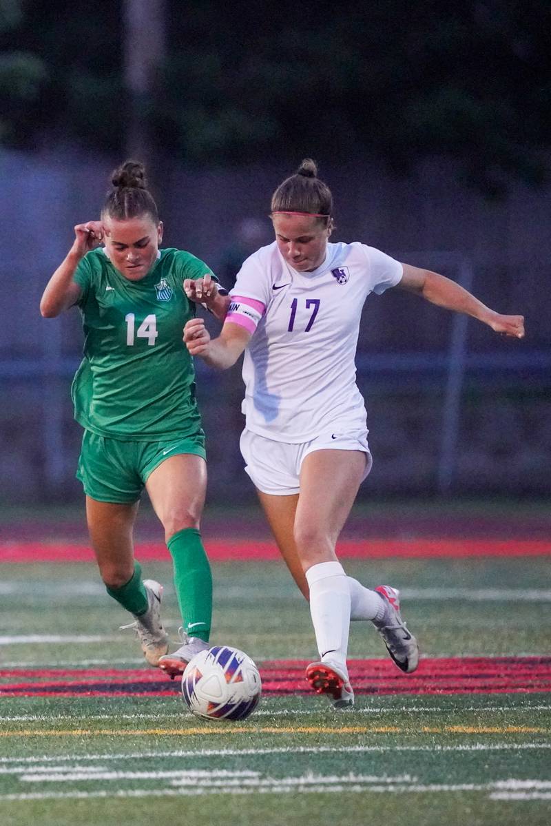 Downers Grove North's Lexi Keown (17) challenges York’s Michaela Quinn (14) for the ball during a Class 3A Hinsdale Central Sectional semifinal soccer match at Hinsdale Central High School in Hinsdale on Tuesday, May 21, 2024.