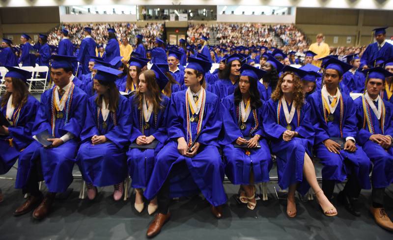 Joe Lewnard/jlewnard@dailyherald.com
Graduates seated in the front row watch as classmates receive diplomas at the Wheaton North High School graduation, held at the College of DuPage in Glen Ellyn Saturday.