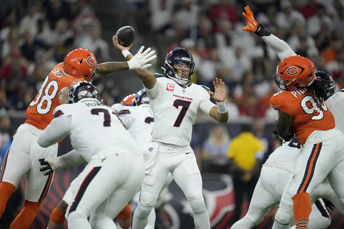 Houston Texans quarterback C.J. Stroud (7) throws under pressure from Chicago Bears defensive lineman Montez Sweat (98) and defensive lineman Zacch Pickens, right, during the first half of an NFL football game Sunday, Sept. 15, 2024, in Houston. (AP Photo/Eric Christian Smith)