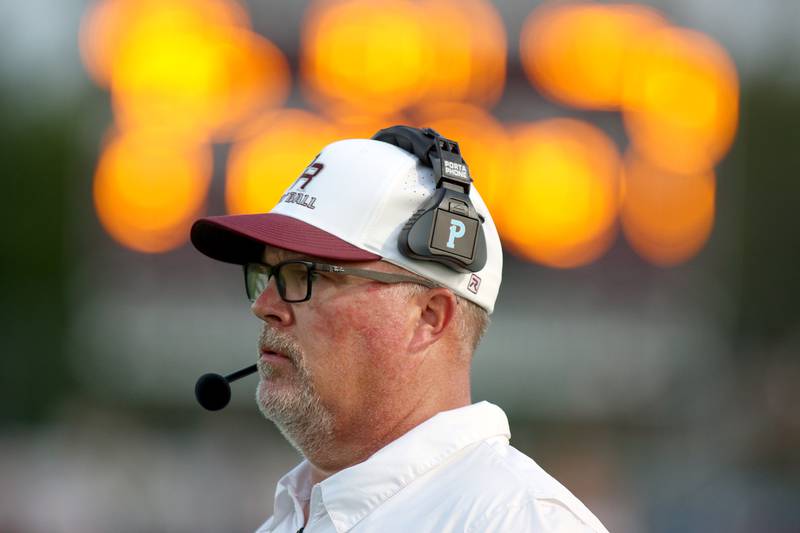 Prairie Ridge Head Coach Chris Schremp leads the Wolves against Jacobs in varsity football at Crystal Lake Friday night. Prairie Ridge won 6-0.