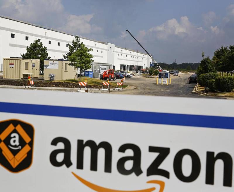 Construction crews work in August to refurbish an existing warehouse along Laraway Road in preparation for an Amazon fulfillment center in Joliet. The company already hired more than 1,000 workers before opening Oct. 7 and plans to hire hundreds more in the coming weeks for the holiday season.