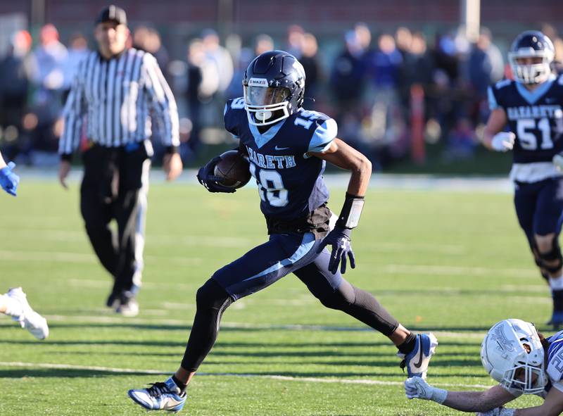 Nazareth's Trenton Walker (19) runs the ball against St. Francis during the boys varsity IHSA 5A semifinal between Nazareth Academy and St. Francis high school in La Grange Park, IL on Saturday, Nov. 18, 2023.