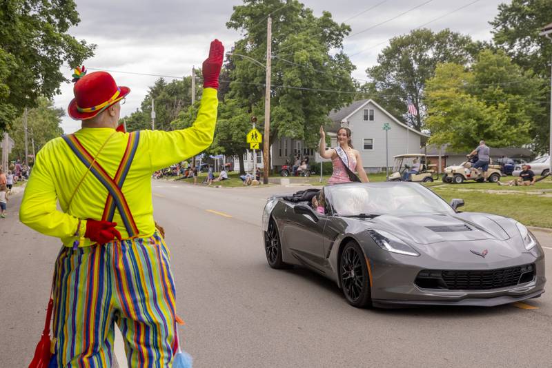 Normal the Clown mirrors the wave of 2023 Bureau County Fair Queen Kelsea Mongan on Saturday, June 8, 2024, during the Buffalo Days parade in La Moille.