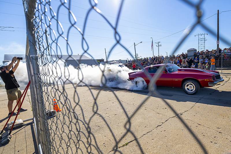 Drivers showcase their engine power by popping the clutch at high rpms and spinning their slicks down the strip Monday, June 10, 2024 in Rock Falls.