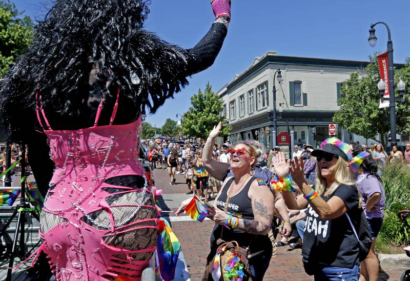 Fans react to the a drag queen during the Woodstock PrideFest Parade on Sunday, June 9, 2024, around the historic Woodstock Square.