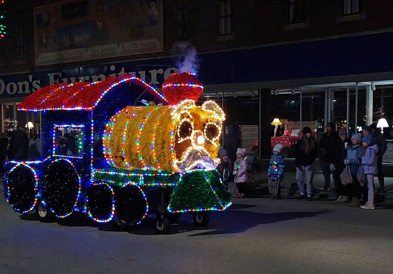 Parade goers watch a lighted train along Main Street on Saturday, Nov. 25, 2023, during the Streator Lighted Christmas Parade.