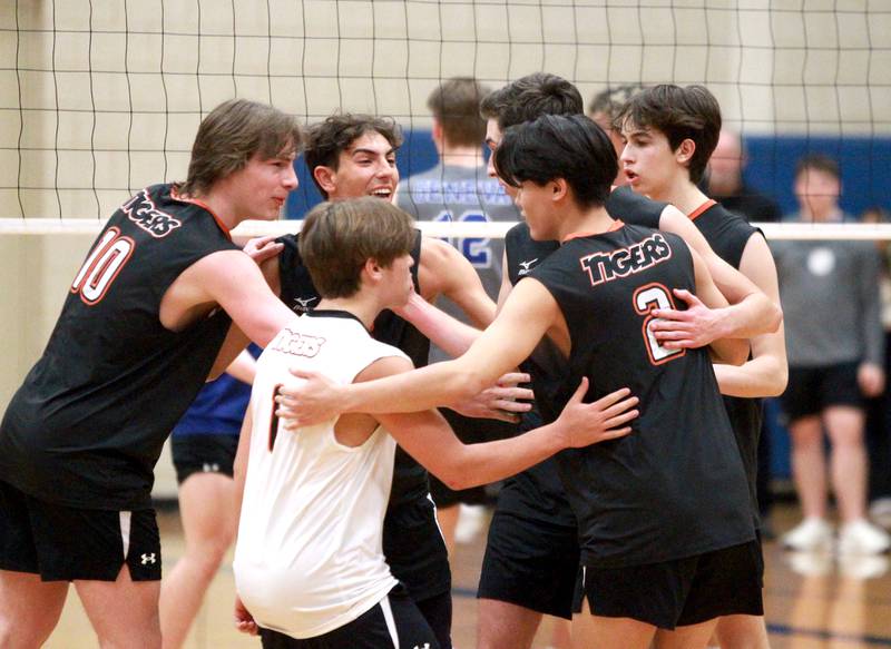 Wheaton Warrenville South players including Simon Bratt (far left) celebrate a point during a game at Geneva on Tuesday, April 2, 2024.