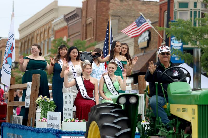 2020 Milk Days Queen Faith Jones, 2021 Milk Days Queen Pieper Fiegel and their courts wave during the Harvard Milk Days parade Saturday, June 4, 2022, in Harvard.