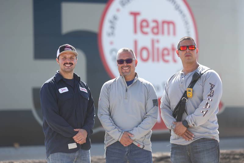 Art Arias Jr. (left) stands with his father Art Arias Sr. and his uncle Enrique Arias at the ExxonMobil plant in Joliet on Sept. 8, 2022, where all three men work.