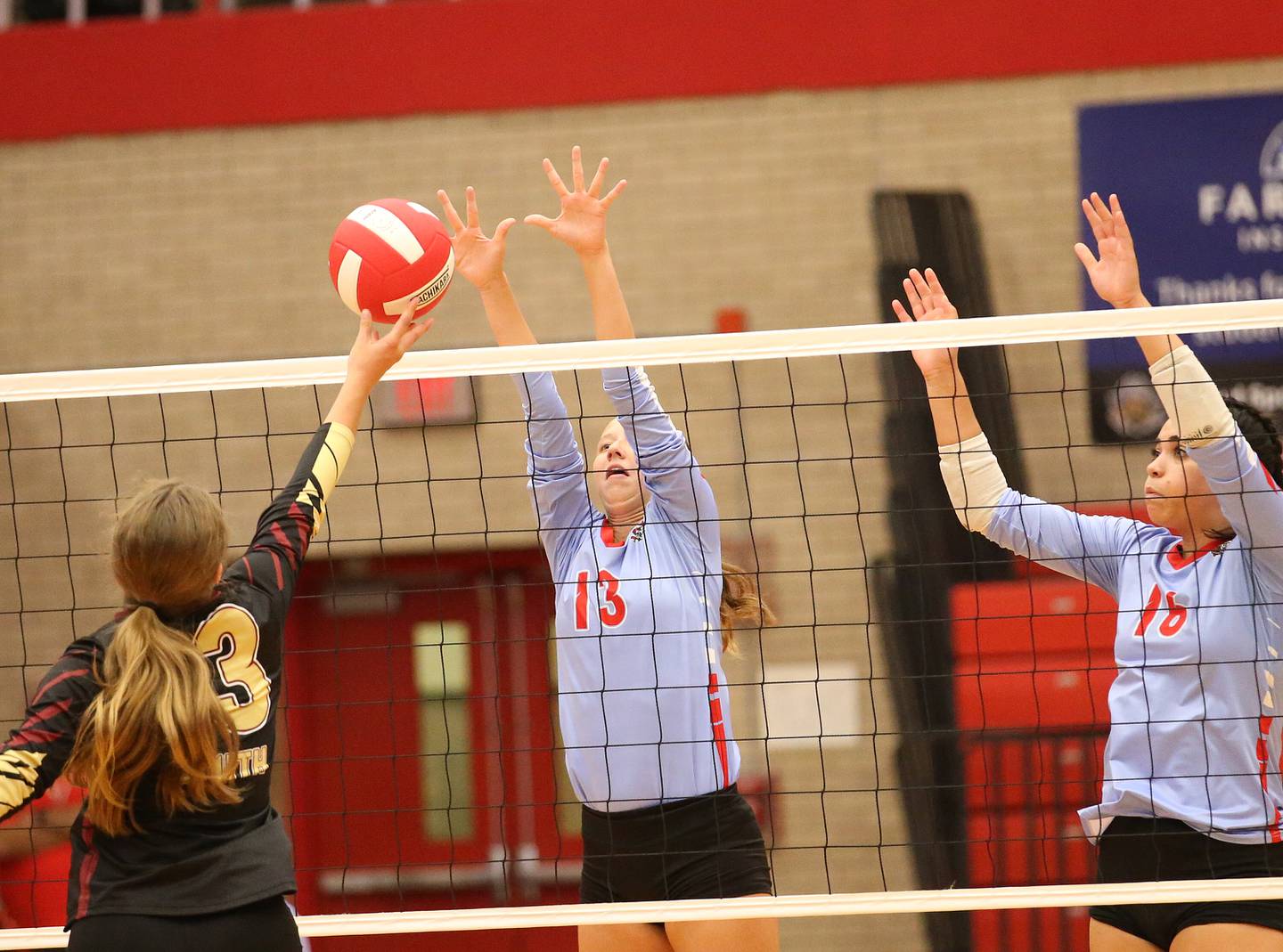 Morris's Ava Smith spikes the ball to Ottawa opponents Alya Dorsey and Chey Joachim on Tuesday, Sept. 12, 2023 in Kingman Gym at Ottawa High School.