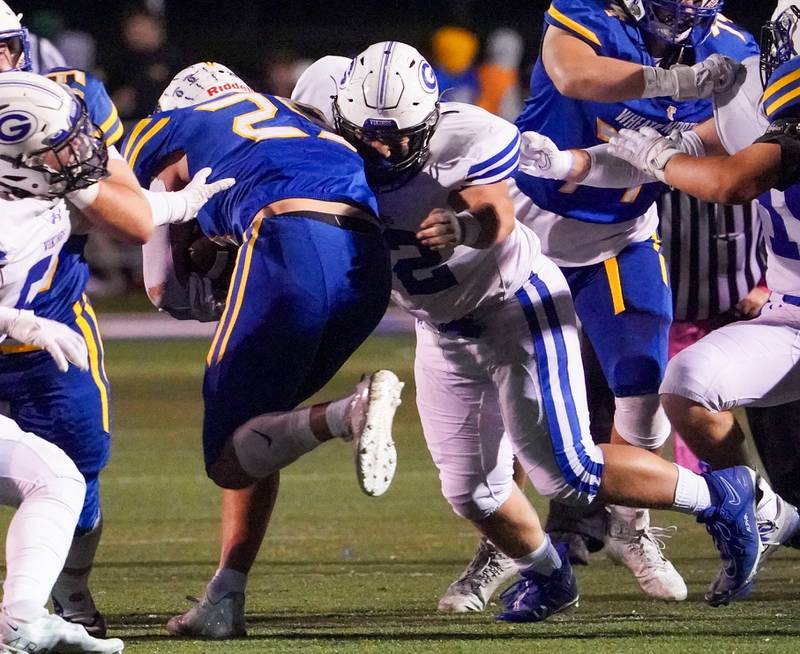 Geneva’s Rino Bianchi (72) shoots the gap to defend against a carry by Wheaton North's Walker Owens (29) during a football game at Wheaton North High School on Friday, Oct. 6, 2023.