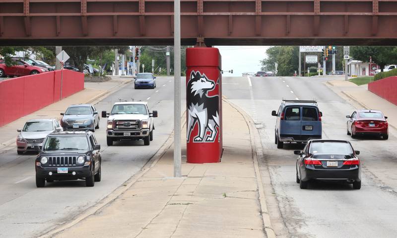 Vehicles drive by part of the new Huskie mural Monday, Aug. 7, 2023, on the Annie Glidden Road railroad underpass, just south of Lincoln Highway in DeKalb. The mural was a joint project between the City of Dekalb and Northern Illinois University.