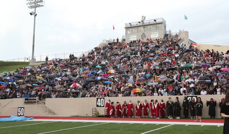 Spectators hold umbrellas as light rain falls before theLa Salle-Peru Township High School graduation on Thursday, May 16, 2024 in Howard Fellows Stadium.