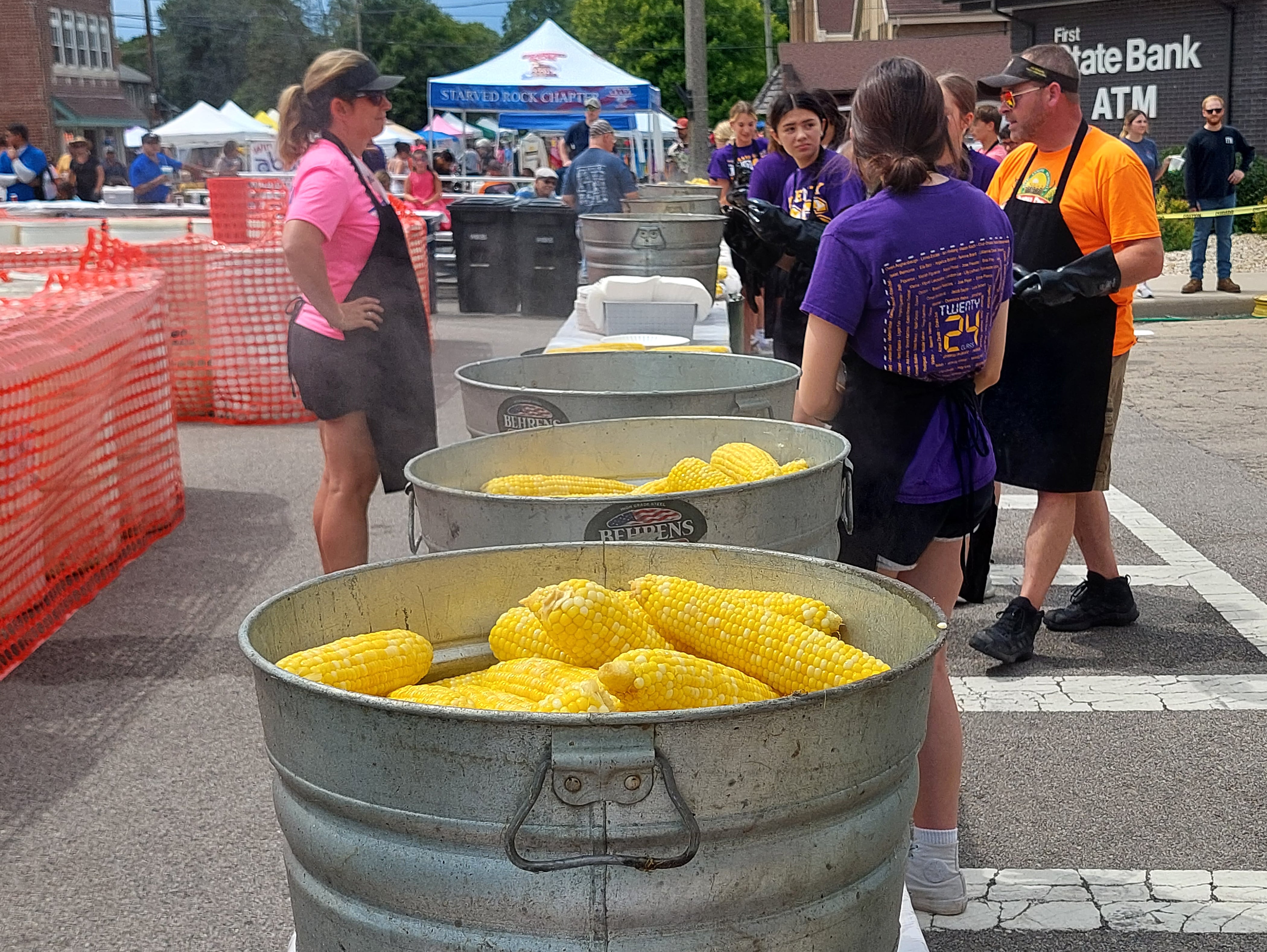 Steaming sweet corn sits in buckets waiting to be distributed Sunday, Aug. 13, 2023, during the Mendota Sweet Corn Festival.