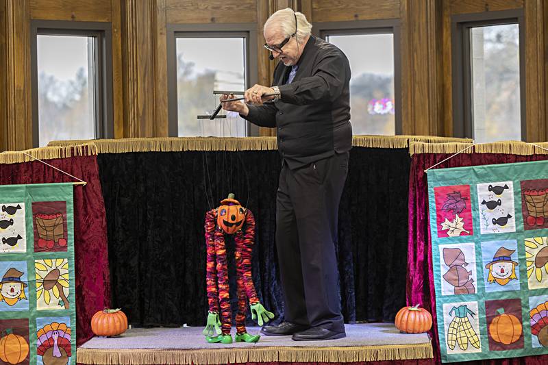 The Pumpkin King dances on the stage as helped by Dave Herzog Thursday, Nov. 16, 2023. A mixture of kids and adults took in the free show.