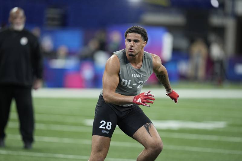 Kansas defensive lineman Austin Booker runs a drill at the NFL football scouting combine in February in Indianapolis.