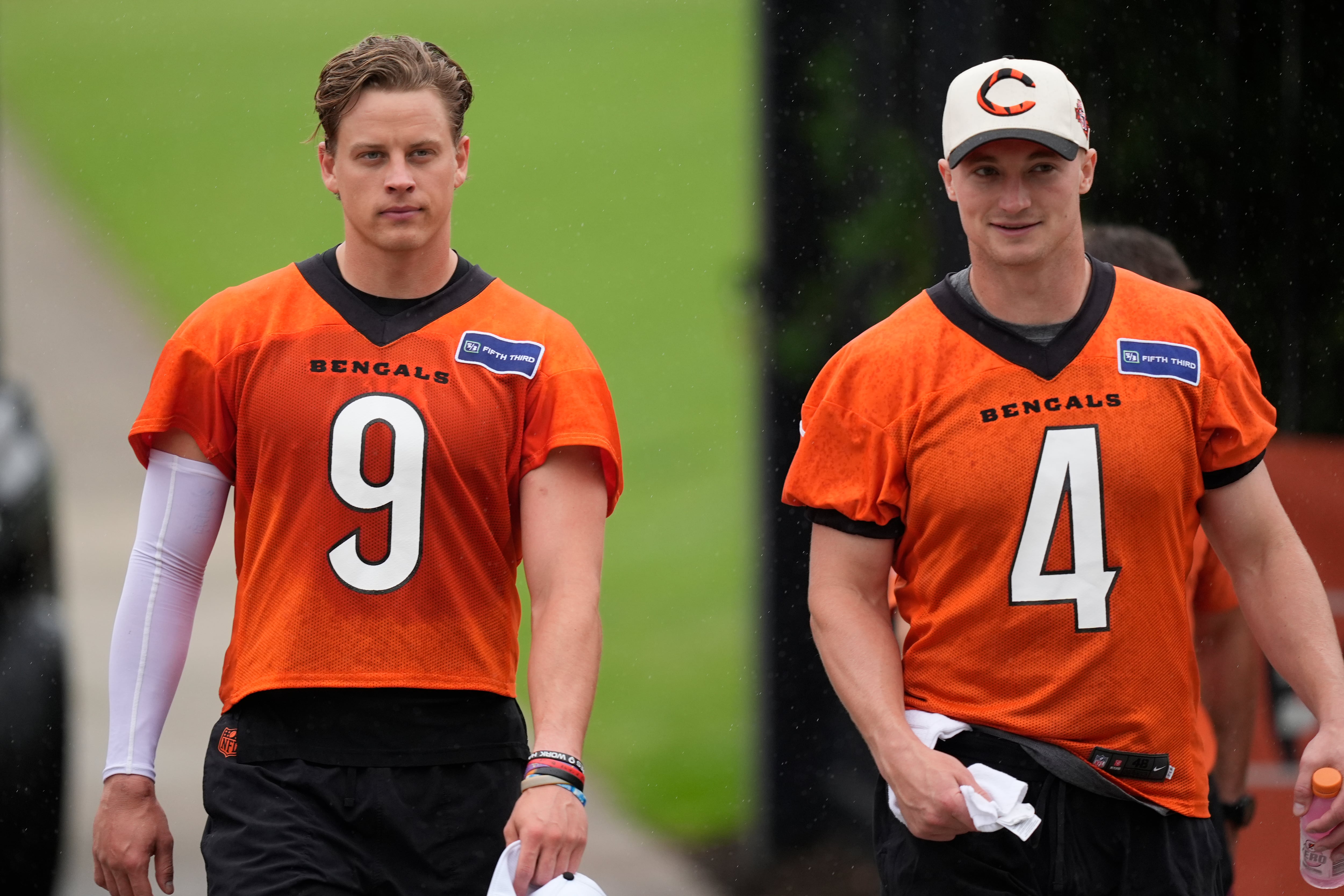 Cincinnati Bengals quarterbacks Joe Burrow (9), and Rocky Lombardi (4) walk from practice fields after the NFL football team's practice on Tuesday, May 14, 2024, in Cincinnati. (AP Photo/Carolyn Kaster)