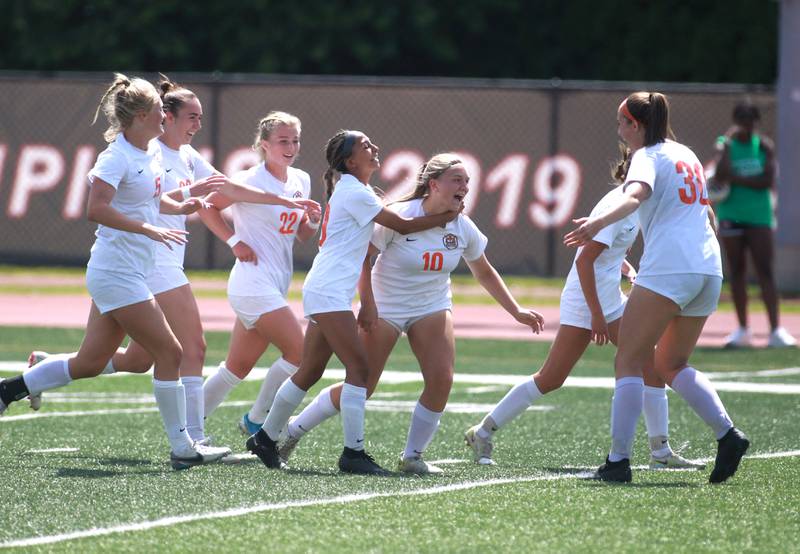 Crystal Lake Central players celebrate a goal by Brooklynn Carlson during the Class 2A state semifinal game against Burlington Central at North Central College in Naperville on Friday, May 31, 2024.