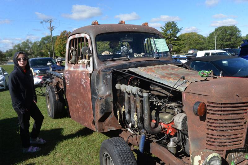Kenzie Whitehead, 11, of Winnebago walks by a "Rat Rod" owned by Bob Renwick of Rockford at the Focus House Foundation Car Show held during Autumn on Parade on Satirday, Oct. 7, 2023 in Oregon.