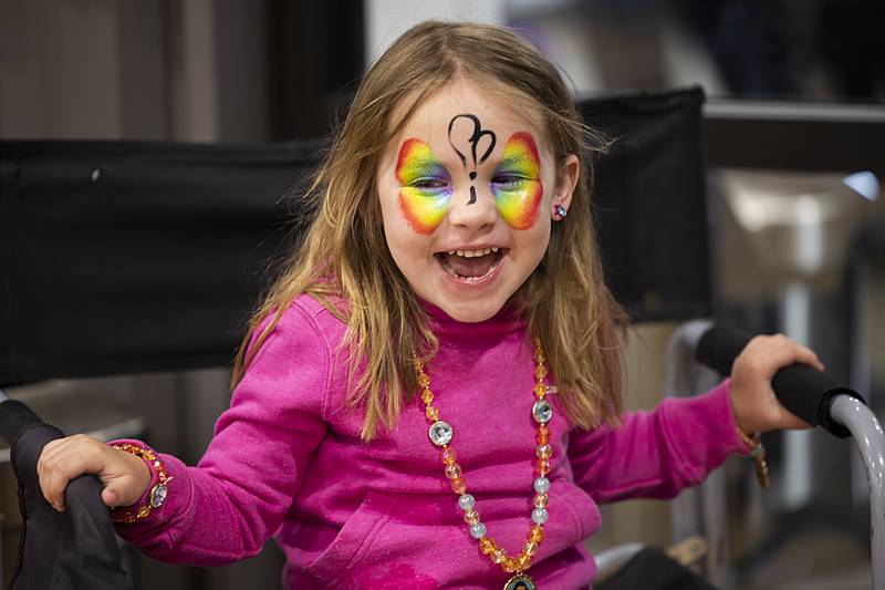 Emory Morgan, 3, of Dixon smiles at the start of her butterfly face paint by artist Kenia Guerin Tuesday, April 2, 2024 during a show by Cirque LuzDalia at Dixon Park District’s The Facility.