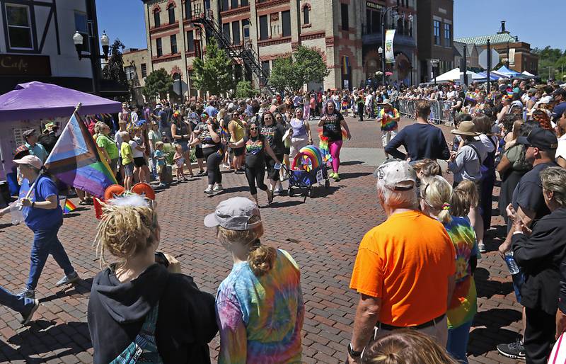 People watch the Woodstock PrideFest Parade on Sunday, June 9, 2024, around the historic Woodstock Square.