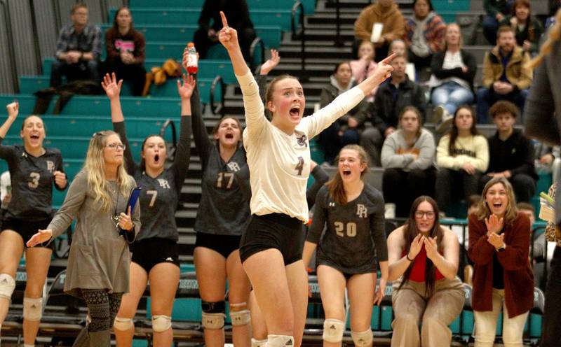 Prairie Ridge’s Alli Rogers and the Wolves celebrate a point against Woodstock in IHSA Class 3A sectional semifinal volleyball action at Woodstock North Monday.