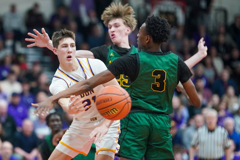Downers Grove North's Jack Stanton (21) passes the ball out of a double team by Waubonsie Valley's Case Valek (25) and Tre Blissett (3) during a Class 4A East Aurora sectional semifinal basketball game at East Aurora High School on Wednesday, Feb 28, 2024.
