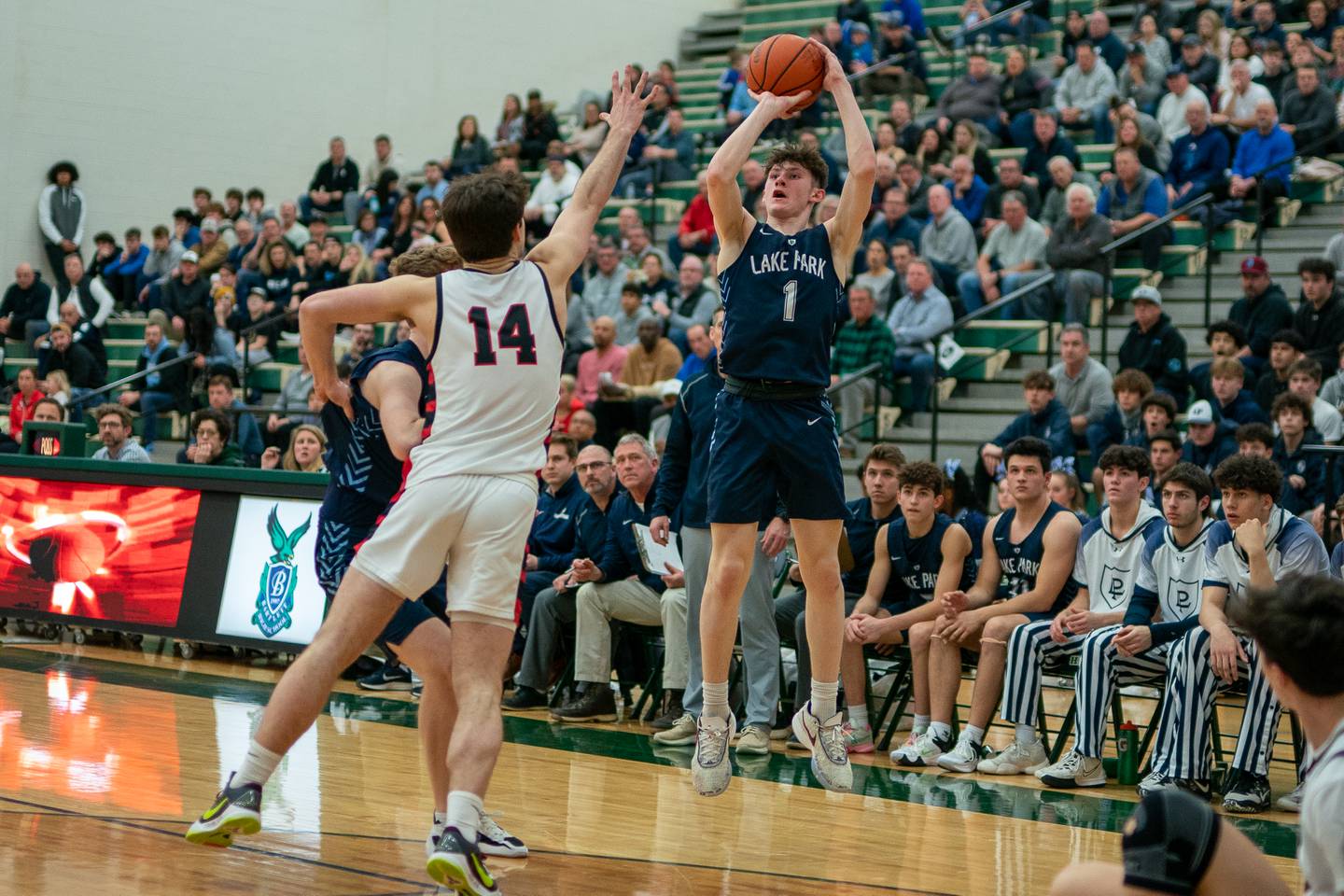 Lake Park's Camden Cerese (1) shoots a three-pointer against Benet’s Parker Sulaver (14) during a Bartlett 4A Sectional semifinal boys basketball game at Bartlett High School on Tuesday, Feb 28, 2023.