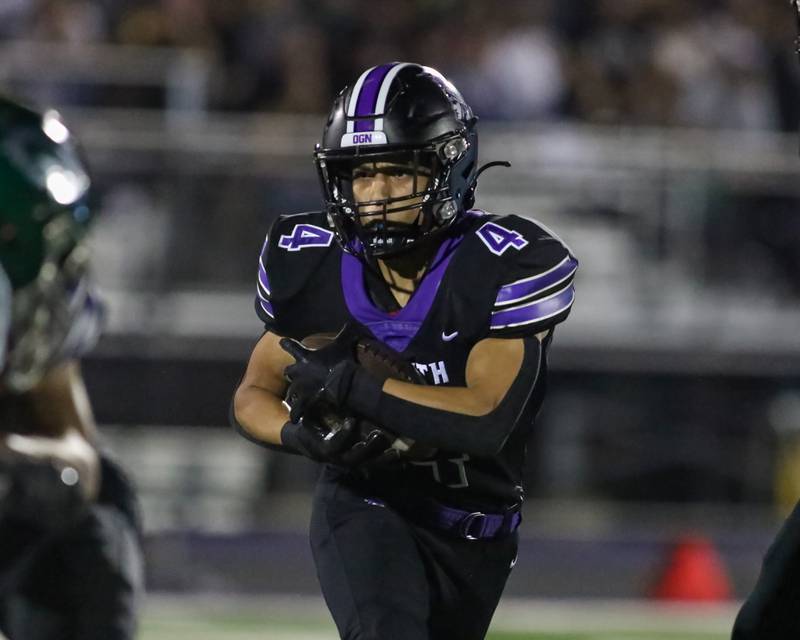 Downers Grove North's Caden Chiarelli (4) looks for running room during a football game between Glenbard West at Downers Grove North on Friday, Sept 13th, 2024  in Downers Grove.