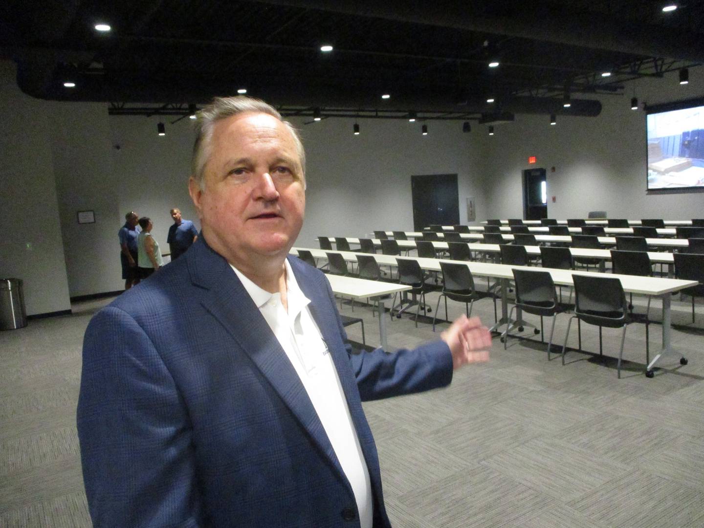 Scott Dworschak, executive director for the Eastern Illinois Chapter of the National Electrical Contractcors Association, points to the expanded auditorium space in the new Joliet Electrical Training Center. Sept. 12, 2024