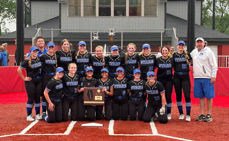 The St. Charles North softball team poses with the sectional plaque after beating St. Charles East in the Class 4A Conant Sectional final.