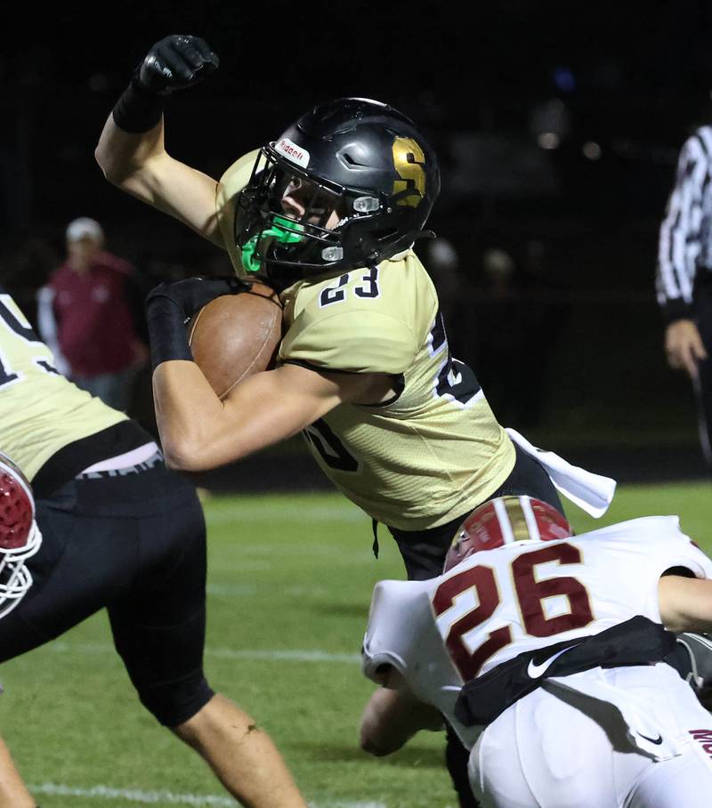 Sycamore's Dylan Hodges tries to dive over Morris' Mick Smith during their game Friday, Oct. 18, 2024, at Sycamore High School.