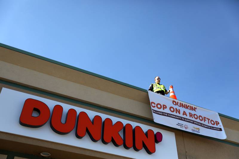 Geneva Police Sgt. Mark Russo stands on the roof at Dunkin’ Donuts at 2002 W. Wilson in Batavia for the Cop on a Rooftop fundraiser to benefit Special Olympics Illinois and the Law Enforcement Torch Run to benefit Special Olympics on Friday, Aug. 19. 2022.