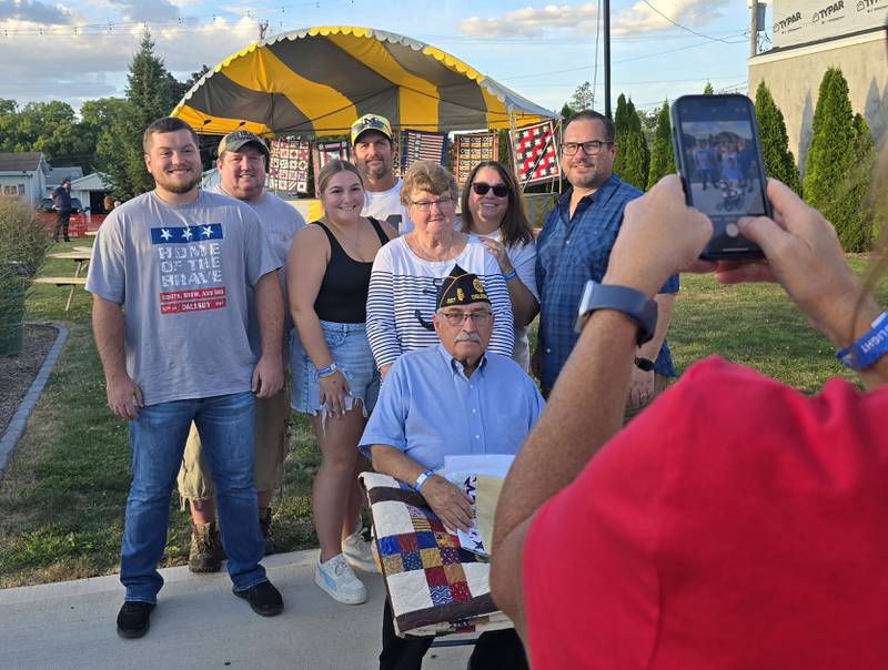 Dominic Rivara is surrounded by family for a photo Sunday, Sept. 15, 2024, after he received a Quilt of Valor at Senica Square in Oglesby.