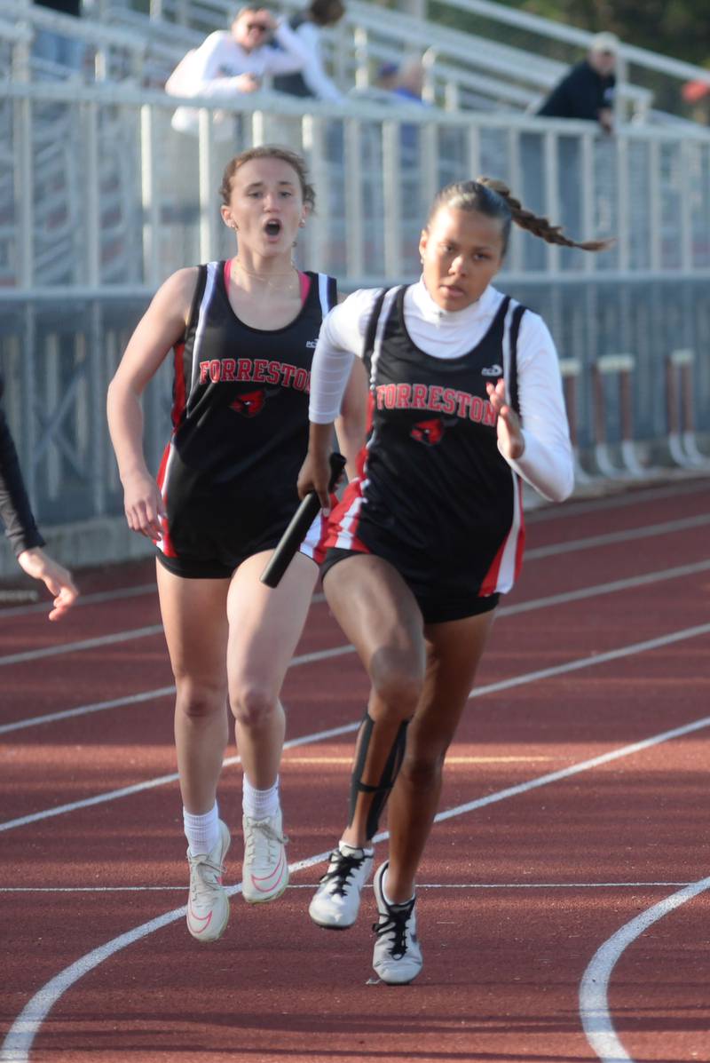 Forreston-Polo's Bree Schneiderman shouts words of encouragement to Letrese Buisker in the second exchange of the 4x100 relay at the 1A Oregon Sectional on Friday. May 10, 2024. The relay team finished in first place in 50.64 seconds, to advance to the state tournament at Eastern Illinois University in Charleston..