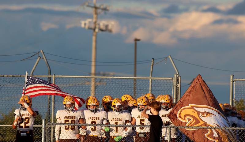 Jacobs’ Golden Eagles prepare to enter the field in varsity football on Friday, Sept. 6, 2024, at Hampshire School in Hampshire.